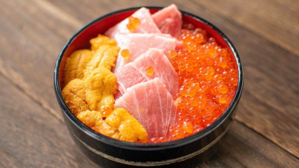 bowl of rice topped with seafood